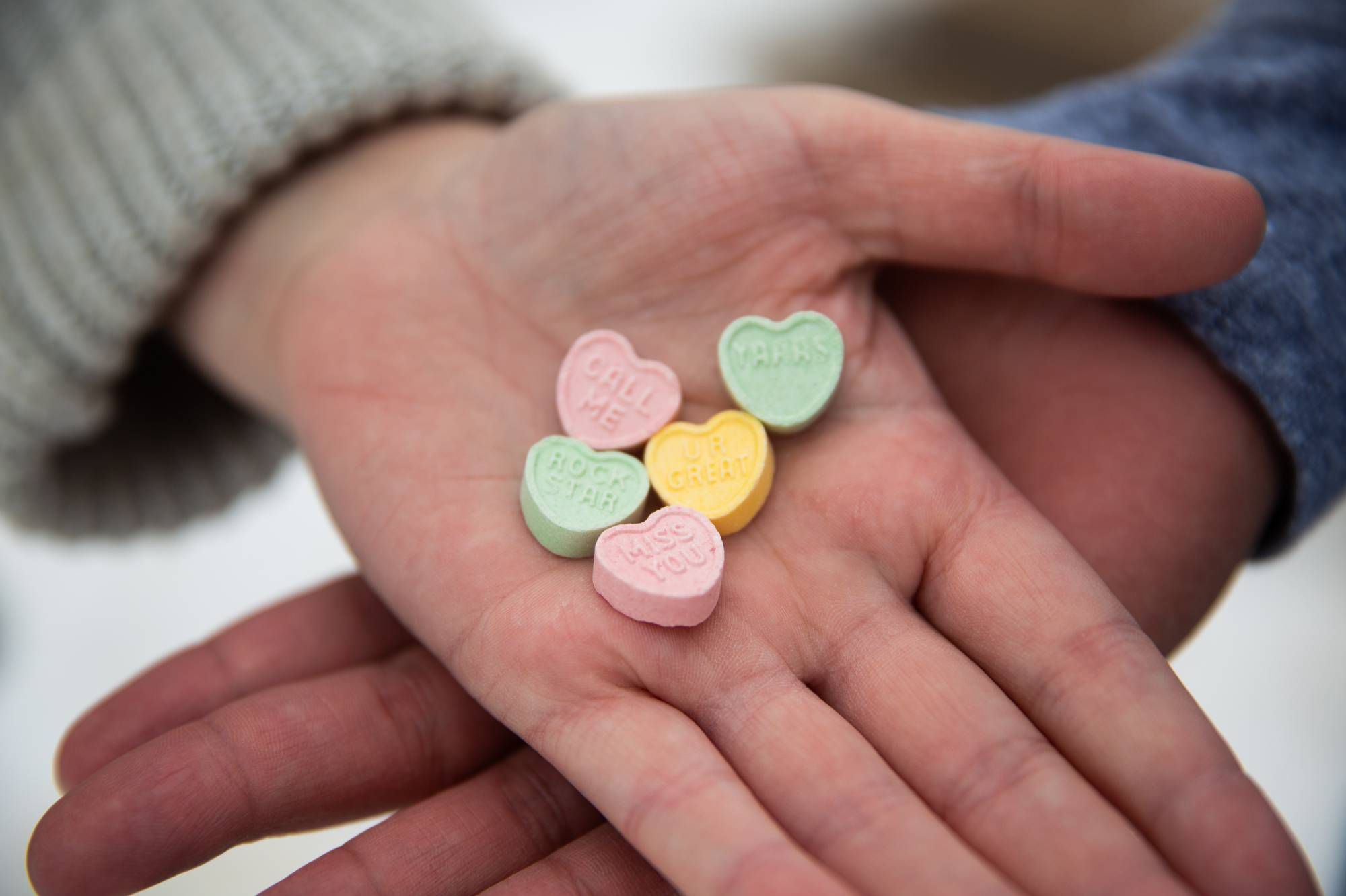 Couple holding heart shaped candies